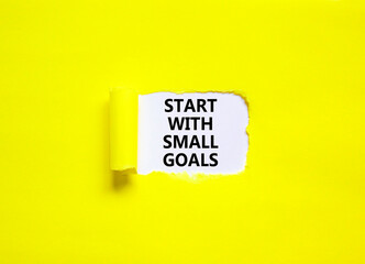 Start with small goals symbol. Concept words phrase Start with small goals on beautiful white paper. Beautiful yellow paper background. Business motivational Start with small goals concept. Copy space