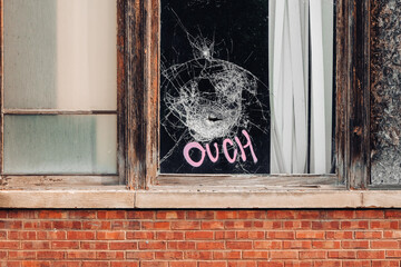 broken window with graffiti 