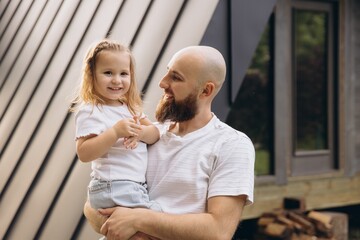 Father holding his smiling daughter in his arms