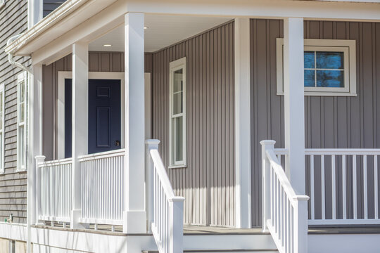 porch entrance to a new home with fence and roof