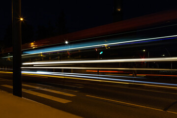 Night motorway transport light lines in city. Light traces Long time exposure dynamic photography. Blurred illuminated transport motion. 