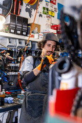 Skilled bicycle mechanic concentrating on brake repair in a busy workshop