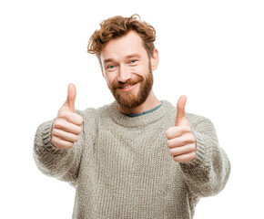 Positive man showing thumbs up in cozy sweater during cold season