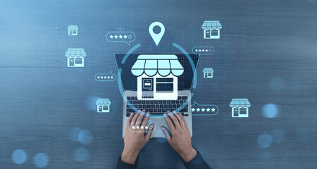 Online store rating system concept with icons over laptop on blue wood background.