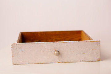 Closeup of a white vintage drawer on a white background