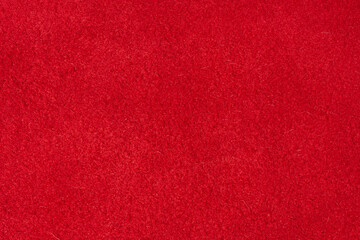 Close up of rich red suede showing the soft, shaggy surface texture with visible fibers