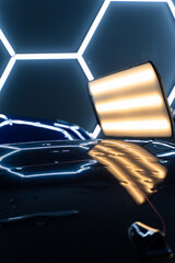 Car panel shows multiple dents under PDR lighting, used in paintless dent repair to expose...