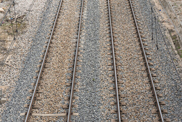 Obraz premium On top of the ballast are sleepers (or ties), cross members that keep the rails at a constant distance and transfer the load from the rails to the ballast.