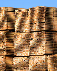 Industrial stack of processed lumber boards end view