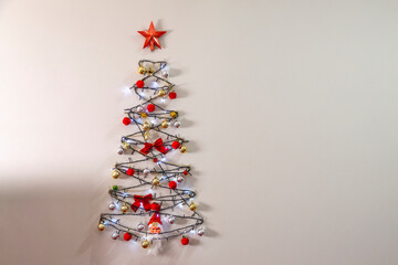 Christmas tree on the wall. Christmas decoration installed on the wall of the house. Space for text. Christmas concept.