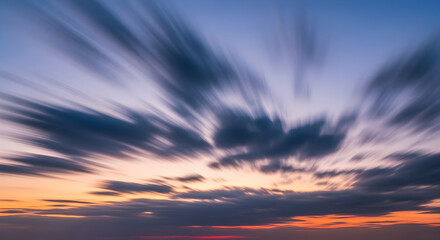 Fototapeta premium Striking Blurred Clouds Paint A Sky At Sunset With Dynamic Movement