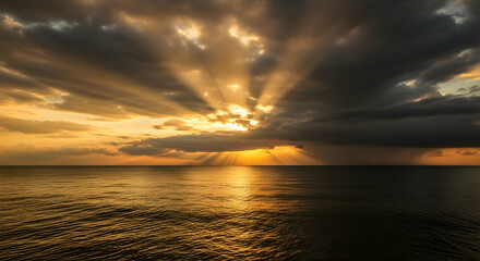 Fototapeta premium Radiant Sea Sunset With Golden Light Beams Breaking Through Stormy Clouds
