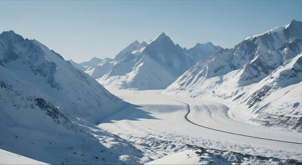 Obraz premium Majestic Snowy Mountain Range With Asphalt Road Through The Valley