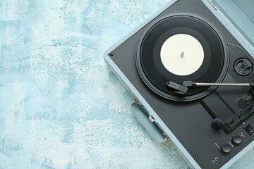 Record player with vinyl disk on grunge background
