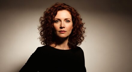 Portrait of a woman with curly hair and serious expression