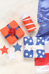 Obraz premium Gift boxes with USA flag and firework rocket on grunge white background. American Independence Day