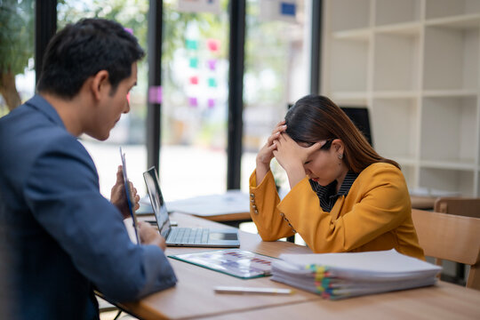 A man and a woman are sitting at a table