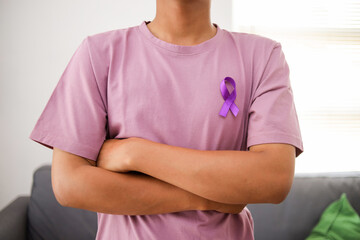 Man with Purple Ribbon Symbol of Fight Cancer Day. World Cancer Day.
