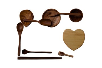 Various wooden kitchen utensils in various shapes isolated on white.