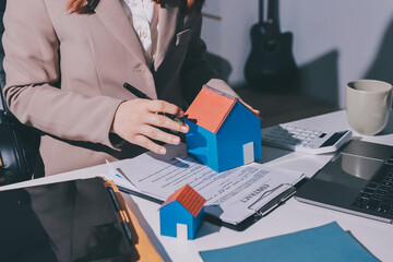 Female Real Estate Broker presenting and advised to .model home and building project detail in the...