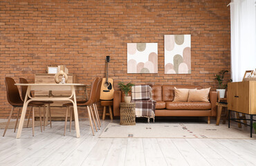 Dining table, chest of drawers and sofa in interior of living room