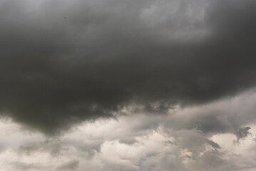 Dramatic dark storm thundercloud rain clouds on black sky background. Dark thunderstorm clouds...