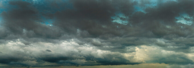 Fototapeta premium Banner Dramatic dark storm clouds black sky background. Dark thunderstorm clouds rainny season. Panorama Meteorology danger windstorm disasters climate. Dark cloudscape storm cloud with copy space.