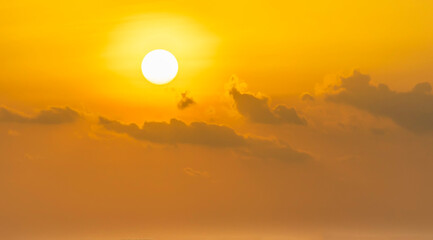 Spectacular sunrise on the horizon with the sea at your feet. Romantic sunrise. Beach sunrises. The sun tries to rise through the clouds in the orange sunrise. Travel and landscape concept.