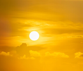 Spectacular sunrise on the horizon with the sea at your feet. Romantic sunrise. Beach sunrises. The sun tries to rise through the clouds in the orange sunrise. Travel and landscape concept.