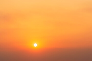 Spectacular sunrise on the horizon with the sea at your feet. Romantic sunrise. Beach sunrises. The sun tries to rise through the clouds in the orange sunrise. Travel and landscape concept.