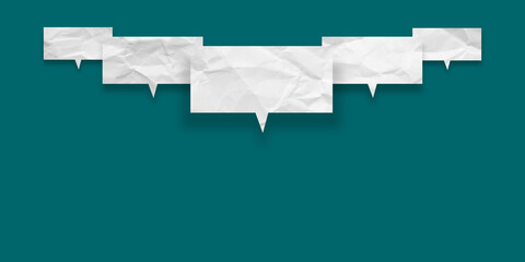 White speech bubble crumpled paper isolated on green background