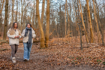 Fototapeta premium Two women walking in the forest. Forest. Nature. Outdoor recreation.
