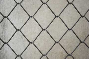 Fototapeta premium old wire mesh on dirty wall, construction industry