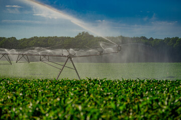 Irrigation equipment. Irrigation system for American farm. Sprinklers watering system. Irrigation system for farm land. Lawn sprinkler watering field. Aerial photo of irrigation used to water plants.