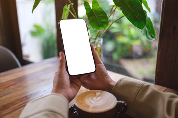 Mockup image of a woman holding mobile phone with blank screen