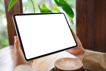 Mockup image of a woman holding digital tablet with blank white desktop screen