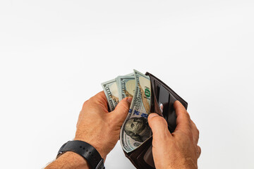 Hands holding dollars while opening a leather wallet
