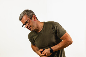 Man experiencing abdominal discomfort in plain background