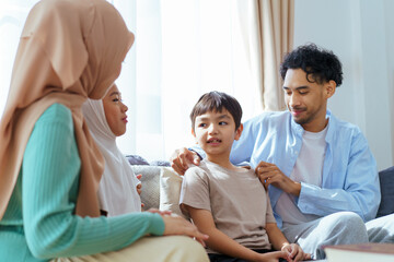 Fototapeta premium Happy Asian muslim family's portrait in living room.