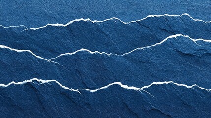 Close-up view of textured blue stone surface with mountain-like patterns.