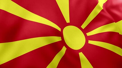 Realistic waving flag of North Macedonia, red field, golden yellow sun with eight rays. Balkan nation symbol, Skopje, patriotism, North Macedonia