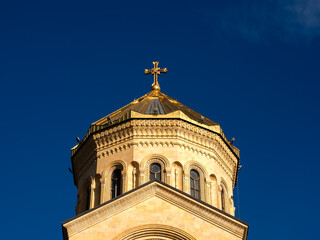 Fototapeta premium The Holy Trinity Cathedral. Tsminda Sameba, close-up cross on the top of the Georgian Orthodox church, beautiful architecture building, famous tourist attraction in Tbilisi, Georgia.
