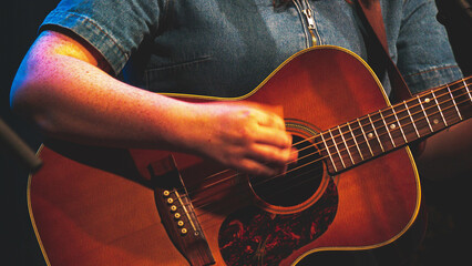 A person playing holding a guitar music close up detail instrument
