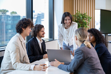 Asian woman sale manager is showing annual report to her colleague in executive meeting for next year plan with market share increase for global business and investment