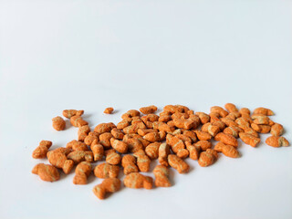 Top View of Dry Fish-Shaped Cat Food Scattered on White Background – Pet Nutrition Concept for Feline Diet and Product Display