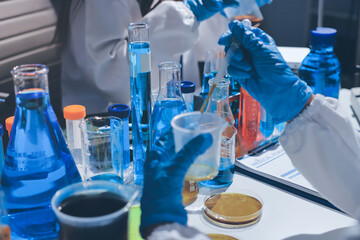Scientist pipetting medical samples into microplate in laboratory