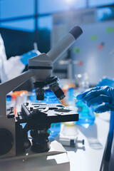 Scientist pipetting medical samples into microplate in laboratory
