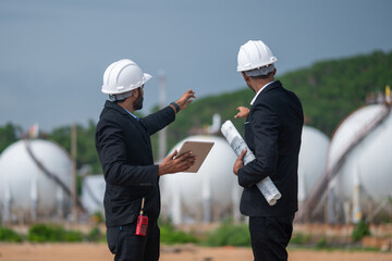 Environmental engineer manager examining waste water along large industrial construction waste...