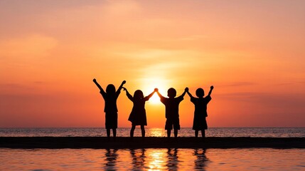 Fototapeta premium Children celebrating joyfully against a beautiful sunset backdrop.