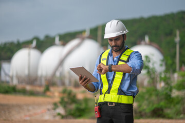 Environmental engineer or workers examining waste water along a large industrial waste water or...